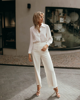 a lady wears a white shirt with white loose fit pants